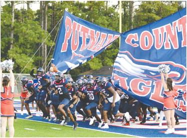 The War Eagles run out onto the field before their game against Jasper County on Friday. IAN TOCHER/Staff 