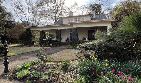 The WH Paul-Peeples house with its beautiful landscaping overtaking the front exterior view. CONTRIBUTED