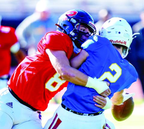 Linebacker Branan Griffin (8) brings down Oconee County quarterback Brody Hannah (2). LANCE MCCURLEY/Staff