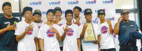 The EMPACT basketball team and coaches display their trophy and championship rings after the national title game. CONTRIBUTED