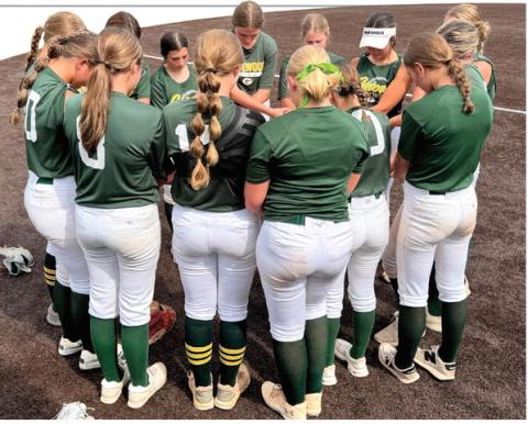 The Gatewood softball team gathers for a prayer before a scrimmage earlier this summer. CONTRIBUTED