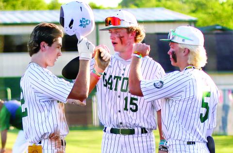 Gatewood’s Ben Brannen (2), Lawson Wooten (15), and Caleb Riser (5) celebrate after winning game one last Friday against the Warriors. TREY NORRIS/Staff