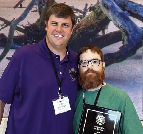 Investigator Clay Wiggins (right) and Ocmulgee Circuit District Attorney Wright Barksdale after the award was announced. CONTRIBUTED