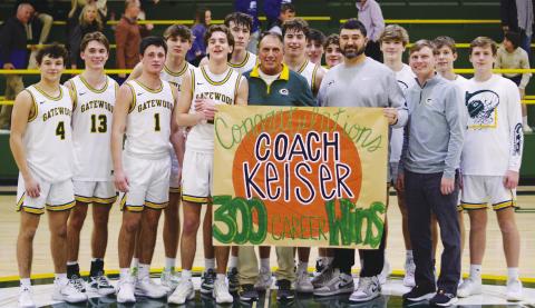 Gatewood head coach Don Keiser (green shirt) enjoyed a moment with his players, including his son, Kaden (13), after they delivered his 300th career win with a 72-53 finish over the visiting Trinity Christian Crusaders. IAN TOCHER/Staff
