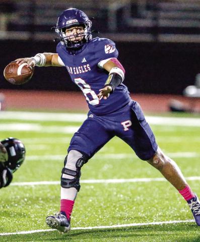 Putnam County’s Branan Griffin rolls out of the pocket as he’s about to fire a pass downfield in Friday’s game against Towers. LANCE MCCURLEY/Staff