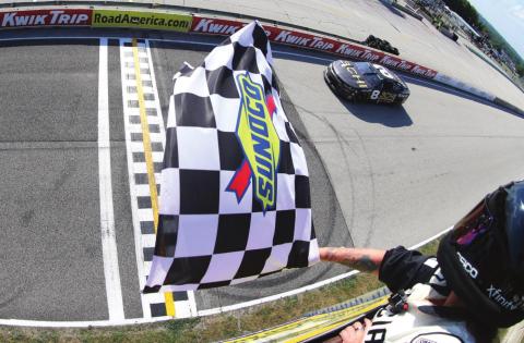 Tyler Reddick, driver of the #8 3CHI Chevrolet, takes the checkered flag to win the Cup Series Kwik Trip 250 at Road America Sunday. (Sean Gardner/Getty Images)