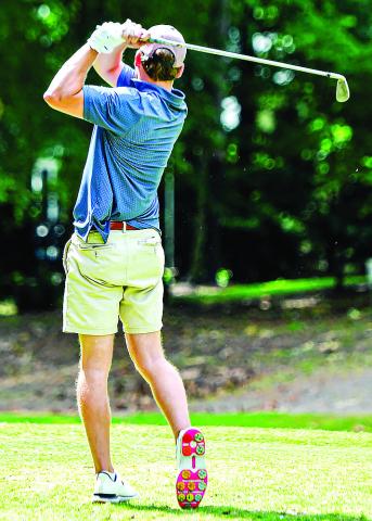 A golfer takes a shot from the fairway during the golf tournament this past Saturday. (CHARLES JORDAN/Staff)