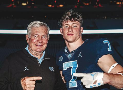 UNC head coach Mack Brown (left) poses for a photo with Gatewood’s Evan Bennett (right) at Kenan Memorial Stadium over the weekend. CONTRIBUTED
