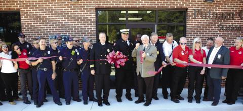 With Putnam County Fire Chief Tom McClain by his side, County Commission Chairman Bill Sharp enthusiastically cut the ceremonial ribbon to officially open the county’s new fire/EMS/coroner facility north of Eatonton, alongside the bypass. IAN TOCHER/Staff