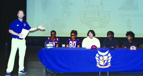 Putnam County head coach Joel Harvin (left) speaks about the five seniors, (l-r) Kavar Andrews, Jason Clemons, Noah Long, Rashod Daniel, and Jamarion Robertson. IAN TOCHER/Staff