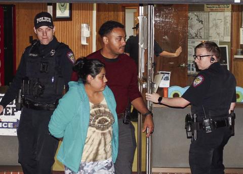 Reyna Lopez, front center, is escorted by Eatonton Police Department officers, from left, Chris Detweiler, Investigator Hargrove Jones and Jeremy McLure, who are taking Lopez to jail at Putnam County Sheriff’s Office. CONTRIBUTED/EPD