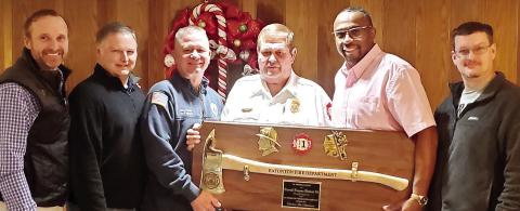 Eatonton Fire Department’s Cooper Rainey, Lt. Jamie Williamson, Assistant Chief Joey Davis, Assistant Chief Carl Buckner and Lt. Carl Vining present Chief Eugene Hubert with his retirement plaque. CONTRIBUTED