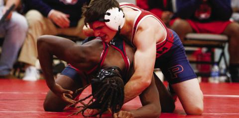 Putnam County senior Wyatt Suggs tries to pin his opponent from Southwest (Macon) at the area duals tournament last Thursday in Social Circle. LANCE McCURLEY/ Staff