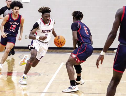 Landon Bonner (2) brings the ball up the floor in transition during a first-round playoff against Toombs County on Feb. 22. LANCE McCURLEY/Staff