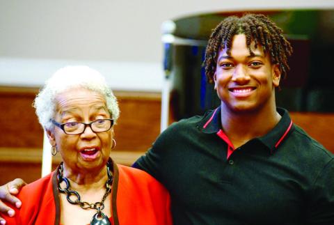Georgia Benjamin-Smith called recent Putnam High grad Amario up from the audience to share a little of his story as he prepares for college life. IAN TOCHER/Staff