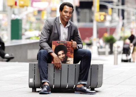 Singer Charl Brown poses on a New York street with one of Smokey Robinson’s record albums. CONTRIBUTED