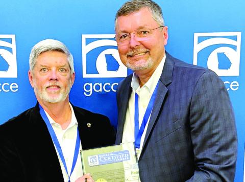 E-PCOC President Robbie King (left) receives a plaque from GACCE Immediate Past Chair and Dublin-Laurens Chamber of Commerce President and CEO Heath Taylor recognizing E-PCOC as an “outstanding” Chamber of Commerce in Georgia. CONTRIBUTED