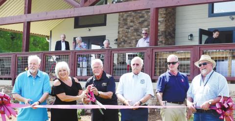 County commissioner Bill Sharp, park managers Susan and Lonnie Campbell, Commission Chairman Billy Webster, County Manager Paul Van Haute and Commissioner Jeff Wooten cut the ribbon. BAILEY BALLARD/Staff