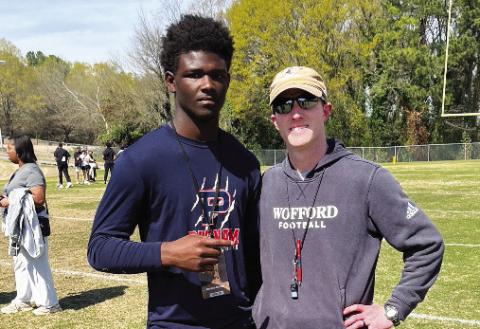 Putnam County junior Bryson Brown (left) with a coach (right) from Wofford University during a practice. CONTRIBUTED