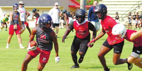 Rising senior DJ Bland catches a pass and tries to find a hole downfield. ARELLA CASH/Staff