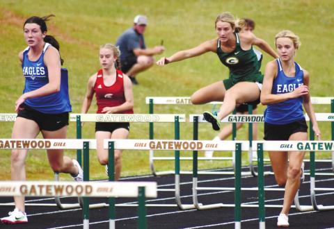 Anna Williamson clears a hurdle in the 100-meter event. T. MICHAEL STONE/Staff