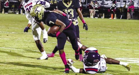 Thomson running back Jordan Lane (7) tries to break away from a Putnam defender in the Bulldogs’ 27-3 win over the War Eagles last season. LANCE McCURLEY/File photo