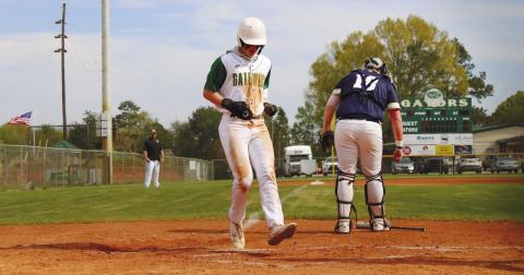 Lawson Wooten (15) reaches home standing up to score another run for the Gators. TREY NORRIS/Staff