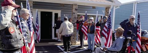 The Honor Flag line supports the wounded veterans as they arrive at the Elks Lodge. LEIGH LOFGREN/Staff