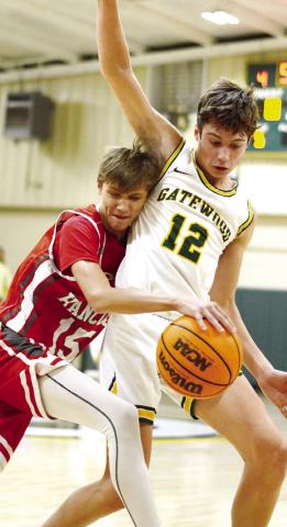 Sophomore Matt Allen (12) defends a shot from a John Hancock guard in the post. IAN TOCHER/Staff