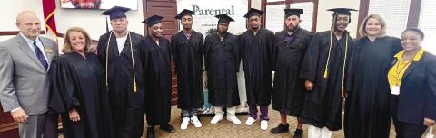 L-R: DCSS Assistant Deputy Commissioner John Hurst and Judge Brenda Trammell pose alongside PAC graduates George Hulsey, Mel-Juwan Lawrence, Bashun Carter, Gregory Burke, Michael Peek, Clarence Hill, Marcus Mathis, Judge Alison Burleson, and PAC Coordinator Zaccino Holmes following Friday’s Parental Accountability Court graduation at Putnam County’s historical courthouse. Not in attendance: PAC graduate James Brock.