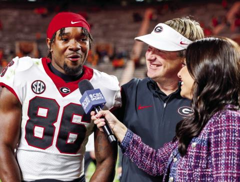 Sophomore wide receiver Dillon Bell threw a touchdown pass, caught five passes for 90 yards and a score while also recording one rush against Tennessee in Knoxville Saturday. Head coach Kirby Smart looks on with a smile during Bell’s post-game interview. COURTESY OF UGA ATHLETICS