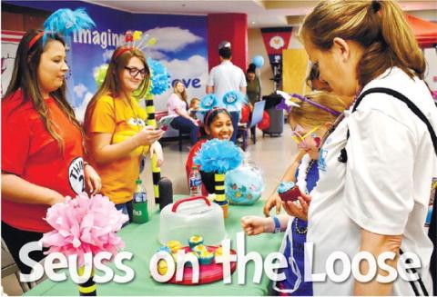 Kimberly Donovan picks a cupcake at the Farmers and Merchants Bank table as her grandma, Linda Manston, looks on.