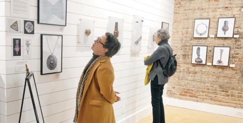 Visitors look at the work of Barbara Mann featured by the Madison Artists Guild during the exhibit’s opening reception Jan. 30. LEIGH LOFGREN/Staff