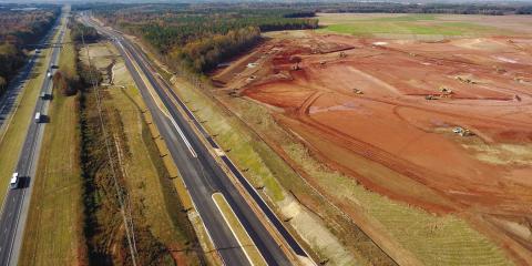 Grading work is underway on the 2,000-acre site where Rivian plans to build an electric vehicle manufacturing plant on the border of Morgan and Walton counties. Also visible is a frontage road, which will connect to a new exit on I-20, seen far left. MARK ENGEL/Staff