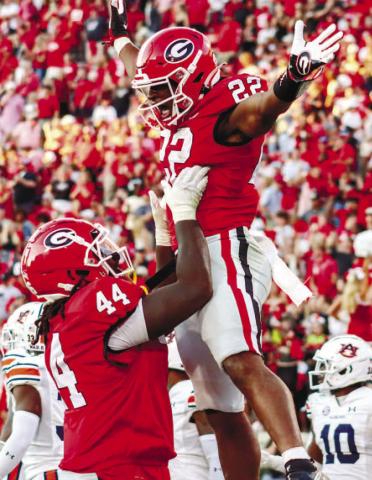 Georgia freshman running back Branson Robinson (22) got his first touchdown in Sanford Stadium Saturday against the Auburn Tigers. He was also the leading rusher in the game. LANCE McCURLEY/Staff