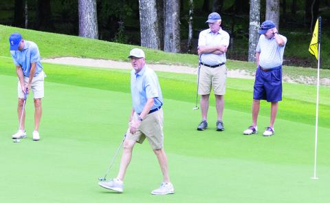 Tom Clements Jr., foreground, reacts to tournament onlookers as he plays The Oconee Cup tournament during the “Alternate Shot” format on the Oconee Course. (LEIGH LOFGREN/Staff)