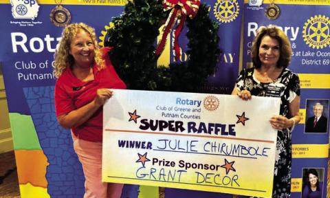 Rotary Raffle prize sponsor Leslie Grant of Grant Decor (left) poses with Rotarian Donna O’Neal in presenting a 36-inch Christmas wreath valued at $300 to Week 35 winner Julie Chirumbole, who was unavailable for the photo. CONTRIBUTED