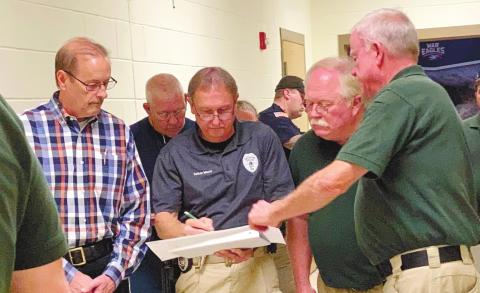 Discussing the entrances and exits of school rooms as they examine the high school’s floor plan are, from left, Eatonton Police Chief Howell Cardwell, Eatonton police Sgt. Harold “Buddy” Bowman and officer/certified instructor Nathan Mason, Putnam County Sheriff Howard Sills and Putnam County Sheriff’s Lt. Harry Luke. LYNN HOBBS/Staff