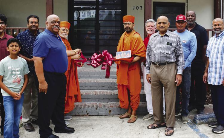 Store owner Neil Patel (third from left) was joined by Eatonton Mayor John Reid (blue shirt), two “saints” from BAPS Mandir, and Eatonton-Putnam Chamber of Commerce CEO Robbie King (red shirt), among others, for a Memorial Day ribbon cutting at Stop N Go, on Eatonton’s Martin Luther King Jr. Drive.