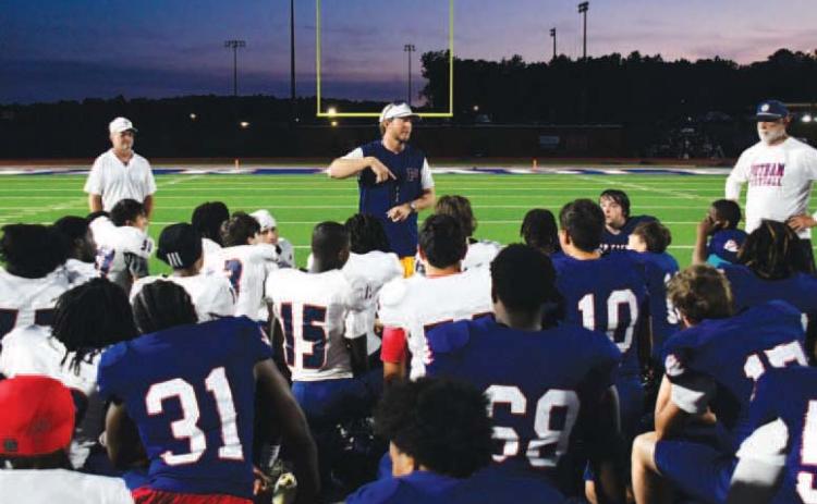 Putnam County High School head football coach Joel Harvin (center) addressed his team following the annual Spring Game to help assess talent and determine positions before the next season begins. IAN TOCHER/Staff