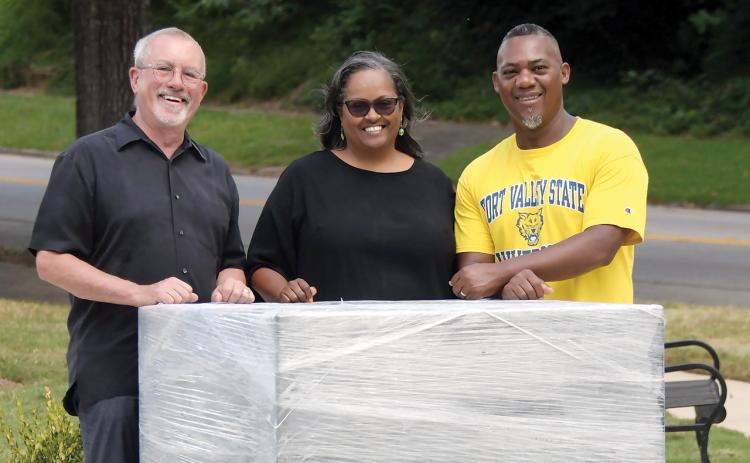 L-R: Kevin Tomson-Hooper is joined by Simone and Grady Jones, posing with the block of granite that will soon support a bronze statue of Eatonton’s own Hiram Little. IAN TOCHER/Staff