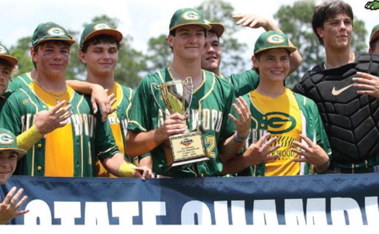 Gatewood players pose with their fourth consecutive state championship trophy last Friday in Statesboro.