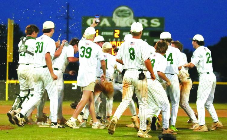 Gatewood celebrates on the field after sweeping Trinity Christian to clinch its sixth straight GIAA Class 2A state championship appearance. TREY NORRIS/Staff