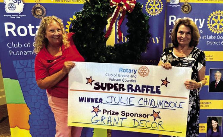 Rotary Raffle prize sponsor Leslie Grant of Grant Decor (left) poses with Rotarian Donna O’Neal in presenting a 36-inch Christmas wreath valued at $300 to Week 35 winner Julie Chirumbole, who was unavailable for the photo. CONTRIBUTED